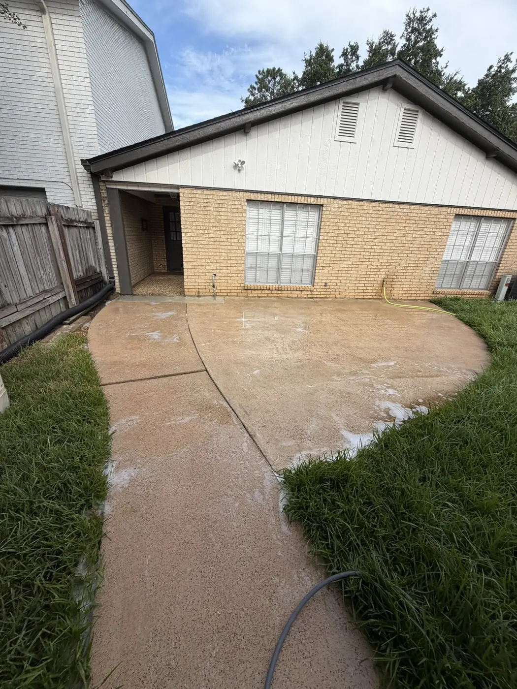 Clean concrete patio after pressure washing in Houston, TX