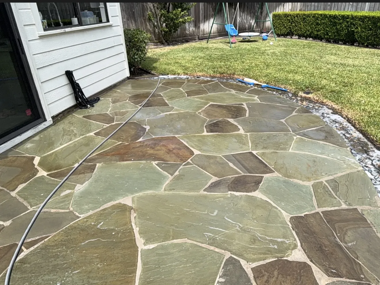 Clean flagstone patio after pressure washing in Houston, TX