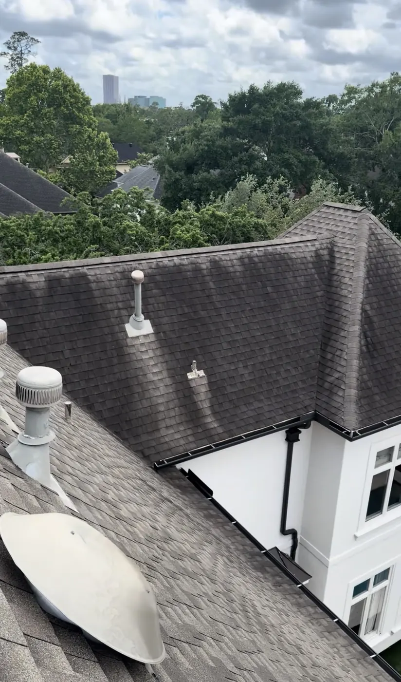 Dirty, algae-darkened asphalt shingle roof in Houston, TX before soft washing