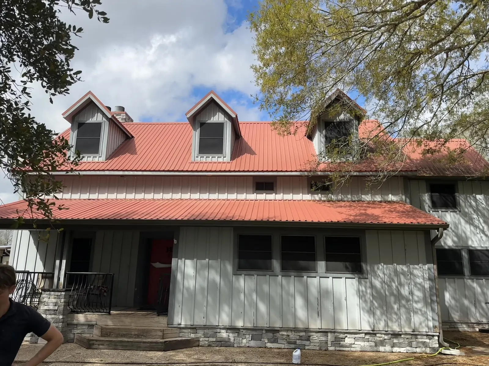 Restored, vibrant red metal roof on the same Houston, TX home after cleaning